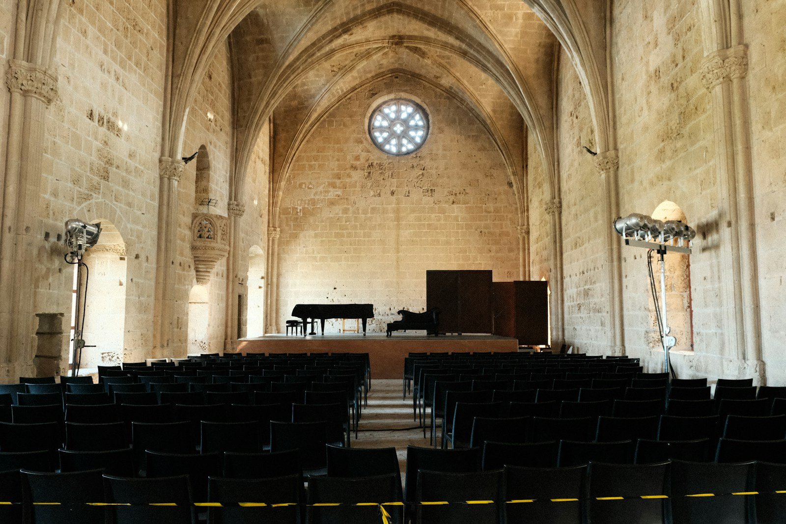 An elegant music hall with grand pianos and recital seating.