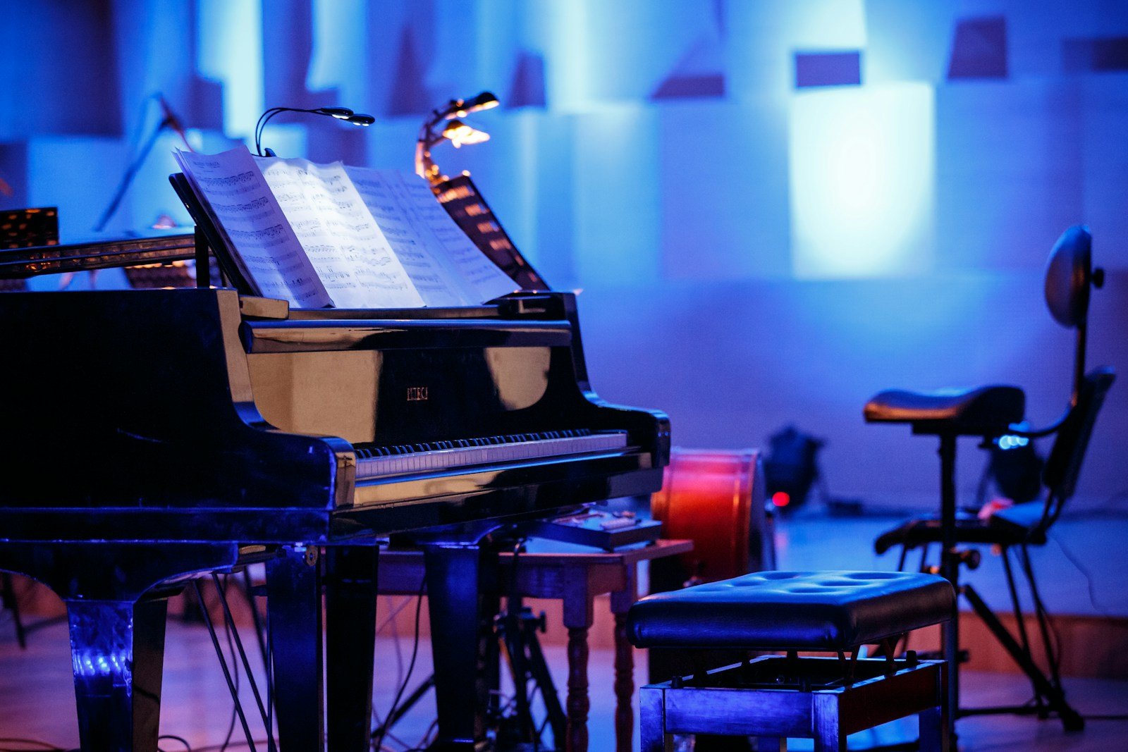 A black grand piano on a quiet stage.